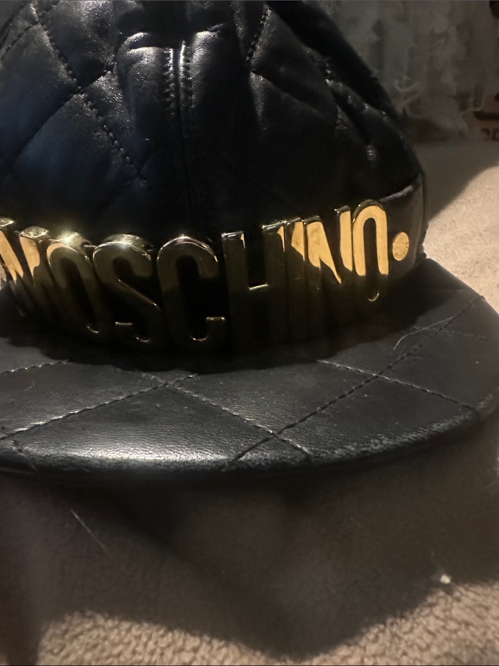 Moschino Black Quilted Leather Cap with Gold Logo Plaque
